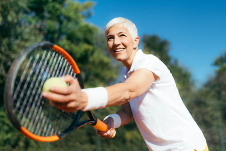 woman playing tennis by vcpt